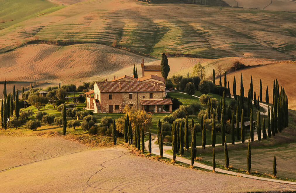Tuscan landscape with country cottage and cypresses